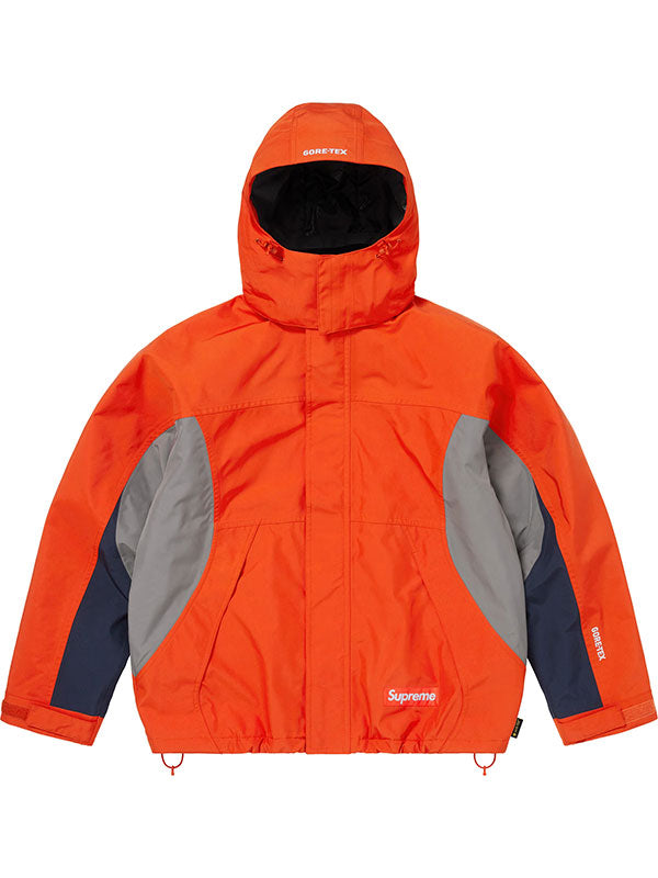 Supreme Peace Gore-Tex jacket in orange colorblock with hood up, shown from the front with the Supreme box logo on the chest.